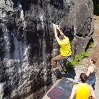 Mark working hard of the small starting holds of a Red problem at Bas Cuvier (Daniel O'Brien)