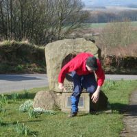 Mark squeezes through Birchover Millennium Stone (Dave Shotton)