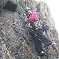 Lucie leading Main Face Climb, Sennen (Roger Dyke)