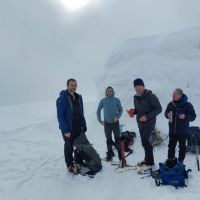 At the summit of The Ben, The iced up emergency shelter behind (Andy Stratford)