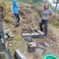 Kate Harvey and Pete Attwood making the first footing for the new stone steps to the knoll